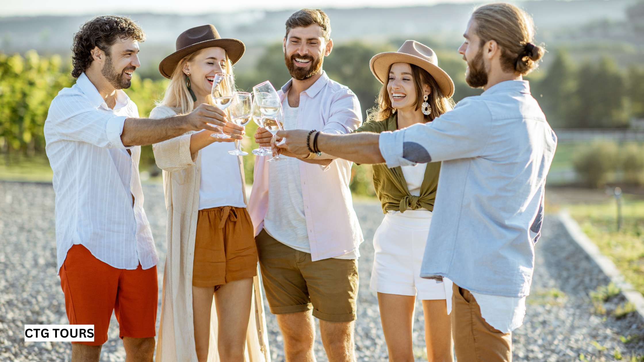 Group enjoying wine in vineyard.